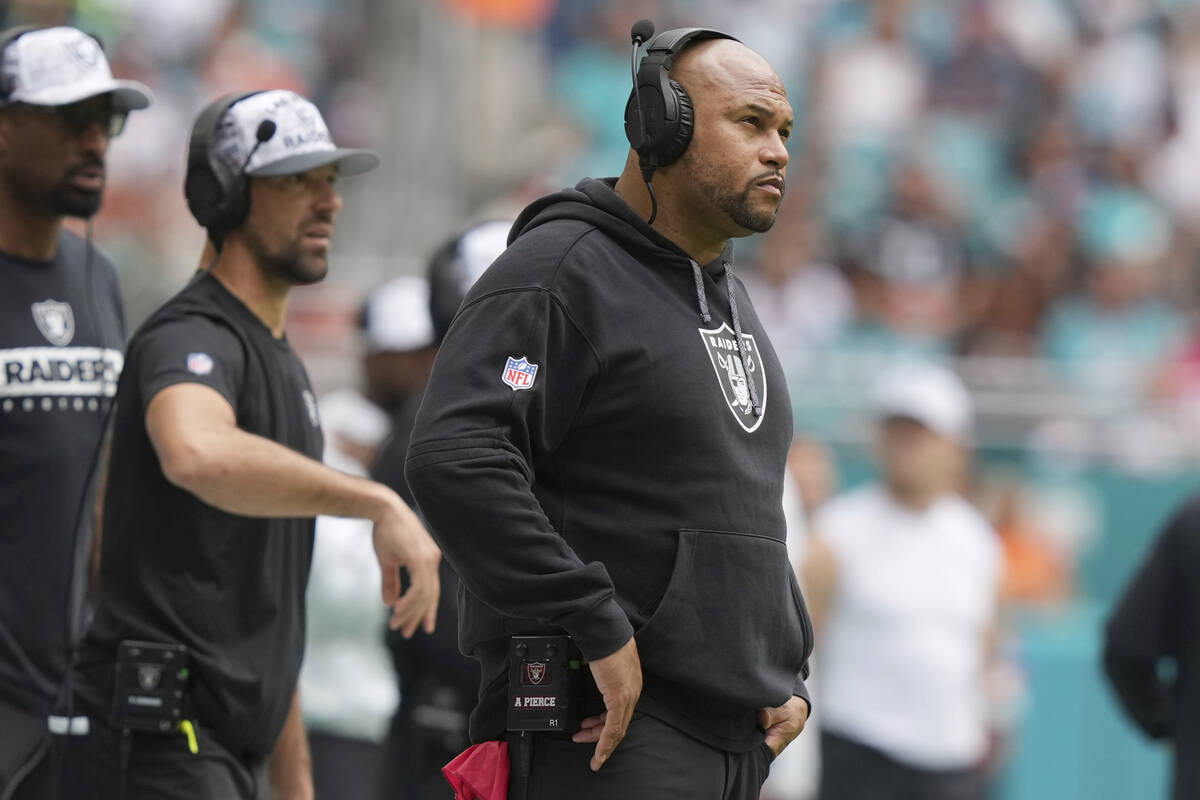 Las Vegas Raiders head coach Antonio Pierce watches from the sidelines during the first half of ...