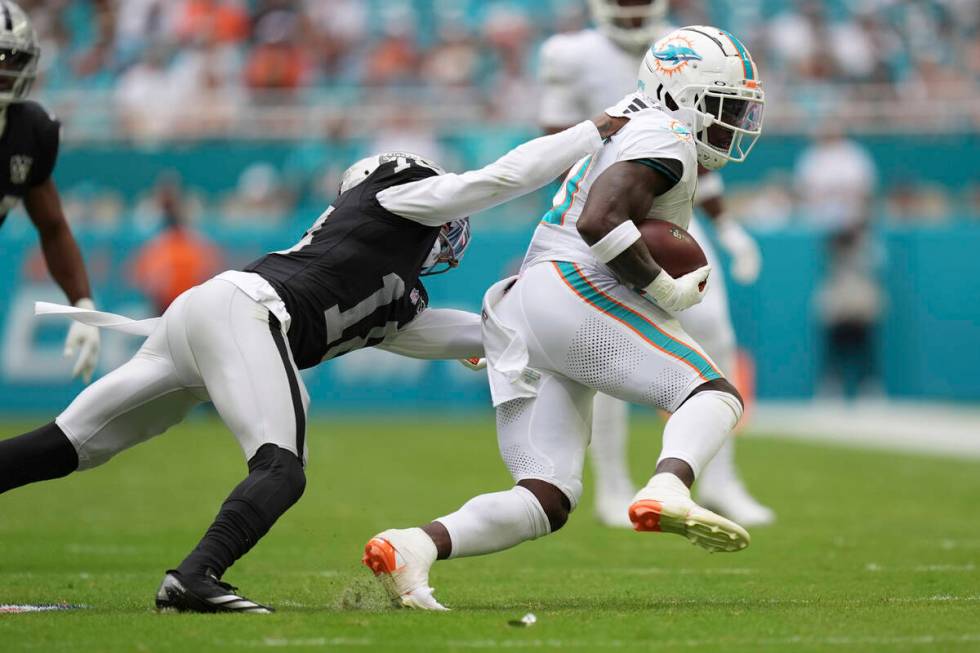 Las Vegas Raiders cornerback Jack Jones (18) grabs Miami Dolphins wide receiver Tyreek Hill (10 ...