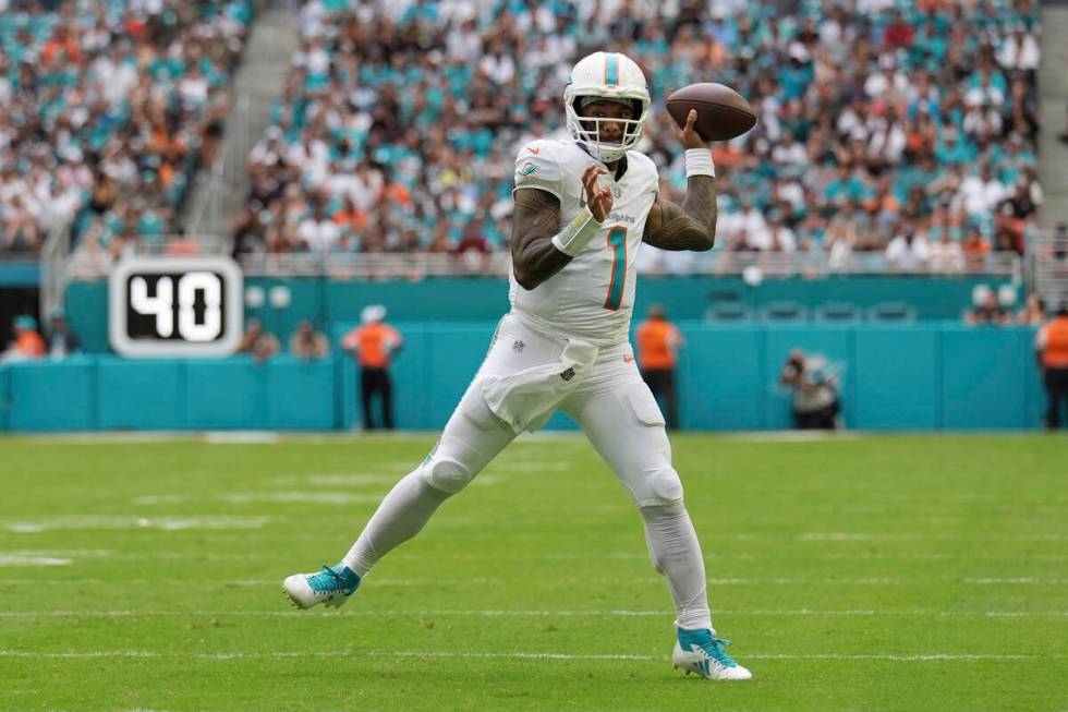 Miami Dolphins quarterback Tua Tagovailoa (1) throws a touchdown pass to wide receiver Tyreek H ...