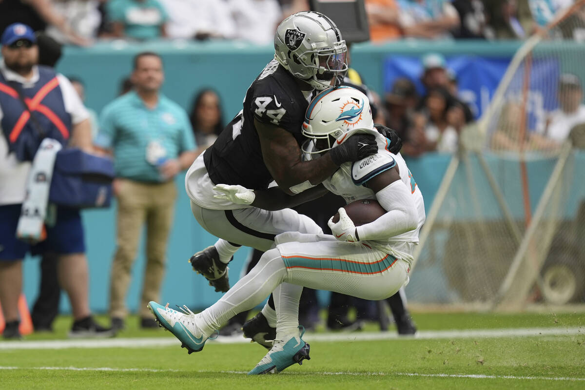 Las Vegas Raiders defensive end K'Lavon Chaisson (44) tackles Miami Dolphins running back De'Vo ...