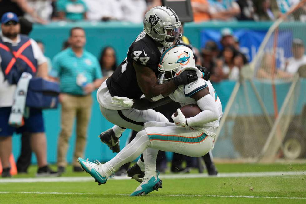 Las Vegas Raiders defensive end K'Lavon Chaisson (44) tackles Miami Dolphins running back De'Vo ...