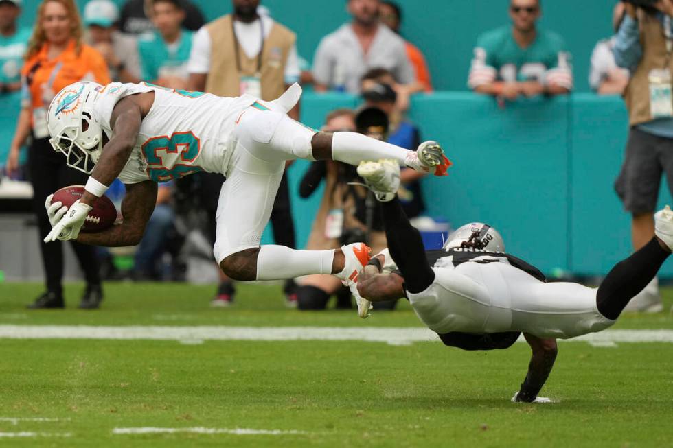 Las Vegas Raiders wide receiver DJ Turner (19) tackles Miami Dolphins wide receiver Malik Washi ...