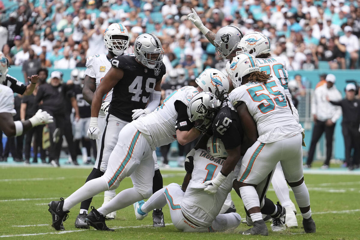 Las Vegas Raiders defensive tackle Adam Butler (69) sacks Miami Dolphins quarterback Tua Tagova ...