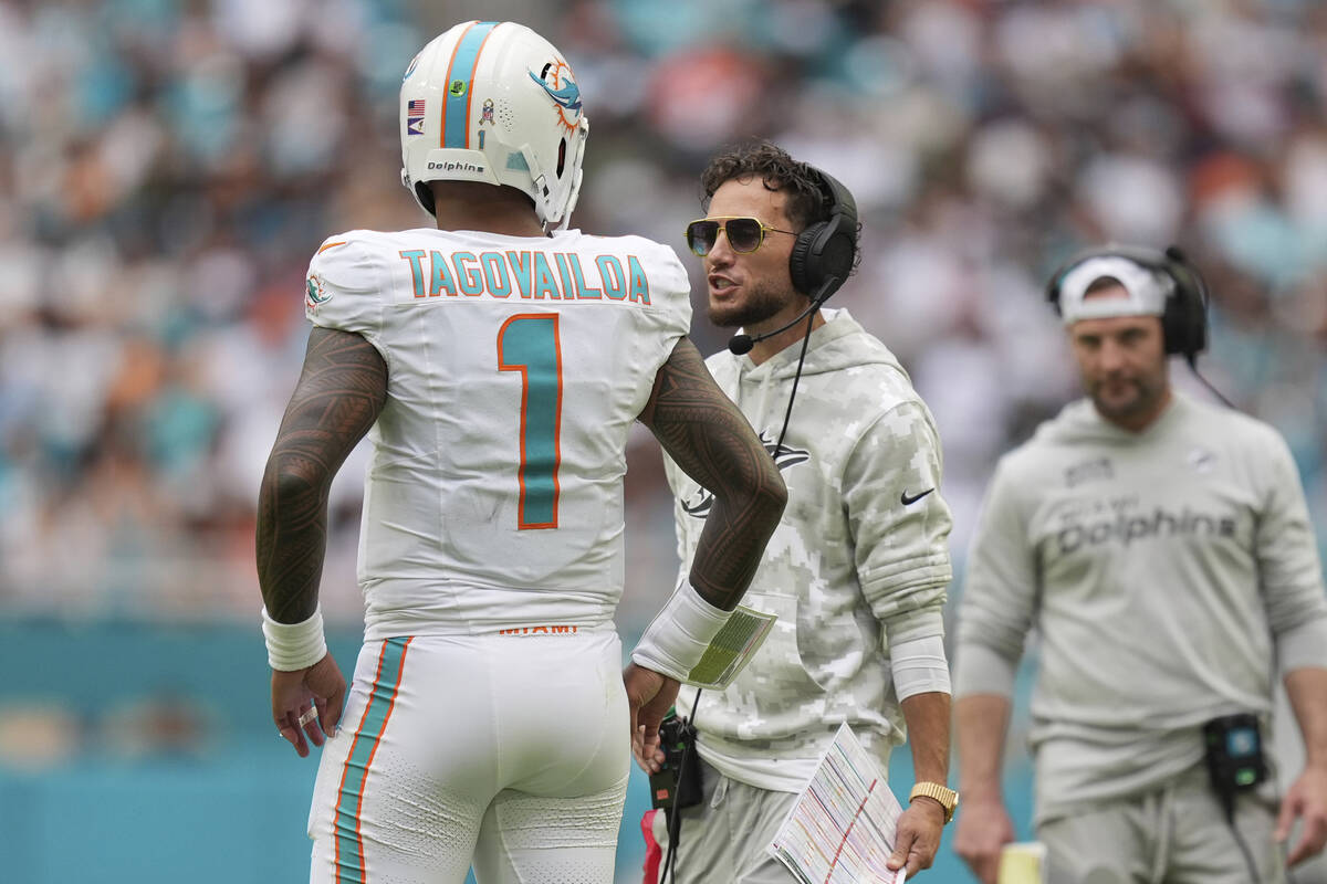 Miami Dolphins head coach Mike McDaniel talks to quarterback Tua Tagovailoa (1) during the seco ...