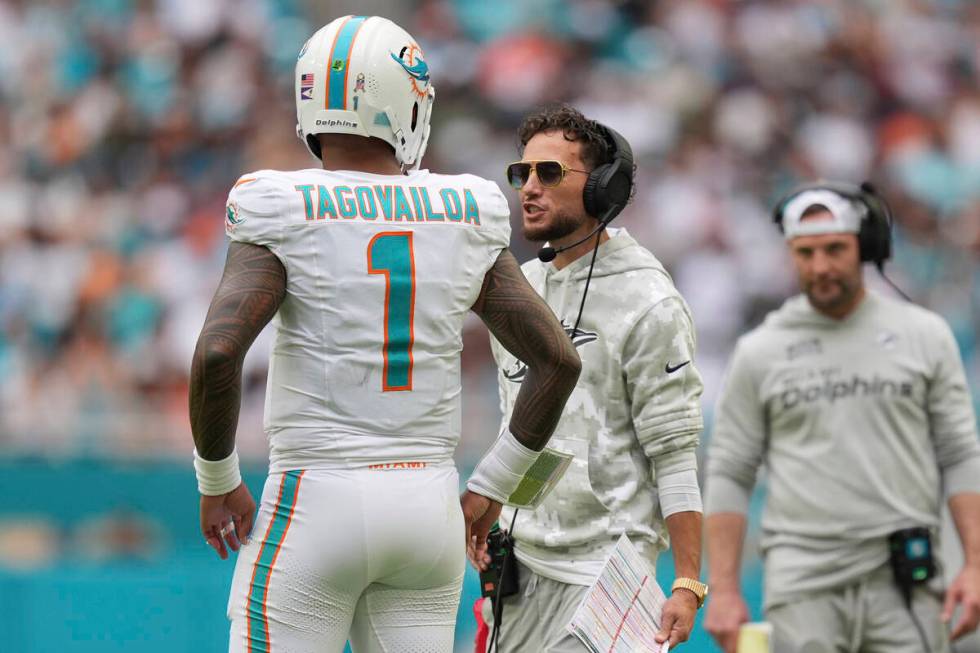 Miami Dolphins head coach Mike McDaniel talks to quarterback Tua Tagovailoa (1) during the seco ...