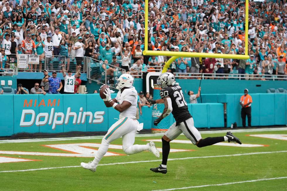 Miami Dolphins tight end Jonnu Smith (9) scores a touchdown as Las Vegas Raiders safety Isaiah ...