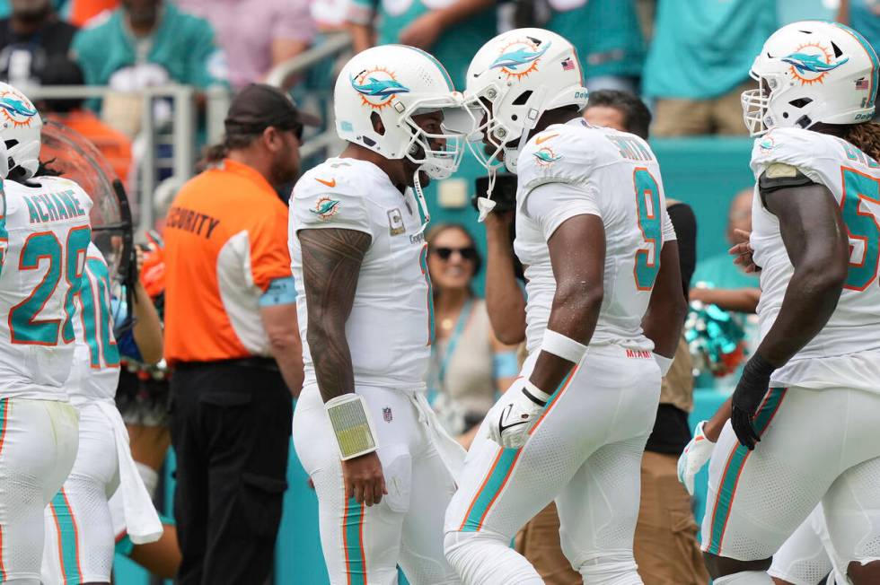 Miami Dolphins tight end Jonnu Smith (9) celebrates his touchdown with quarterback Tua Tagovail ...