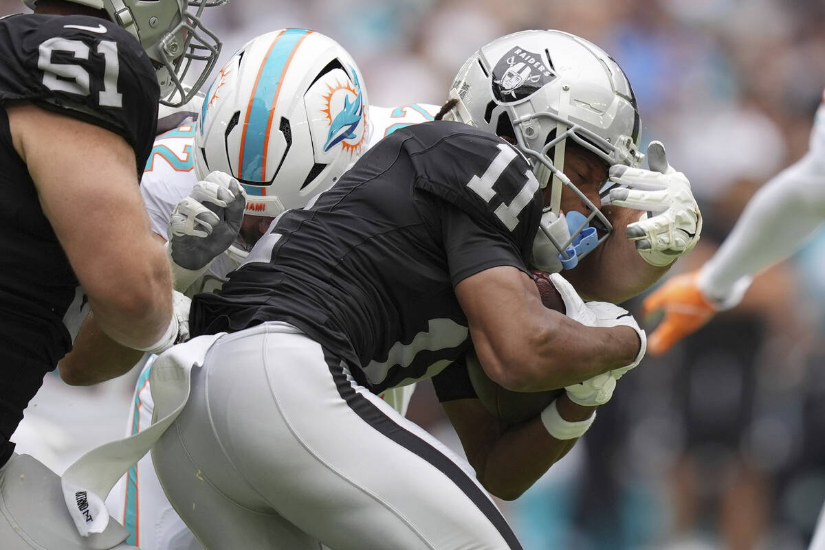 Miami Dolphins defensive tackle Zach Sieler (92) grabs Las Vegas Raiders wide receiver Tre Tuck ...