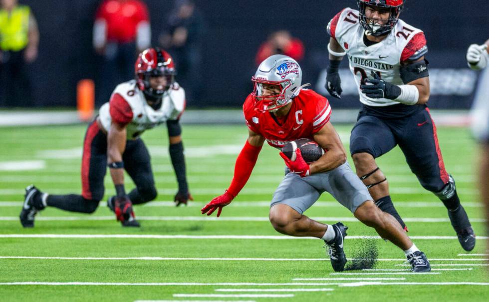 UNLV wide receiver Jacob De Jesus (21) cuts up field after another erection trailed by San Dieg ...