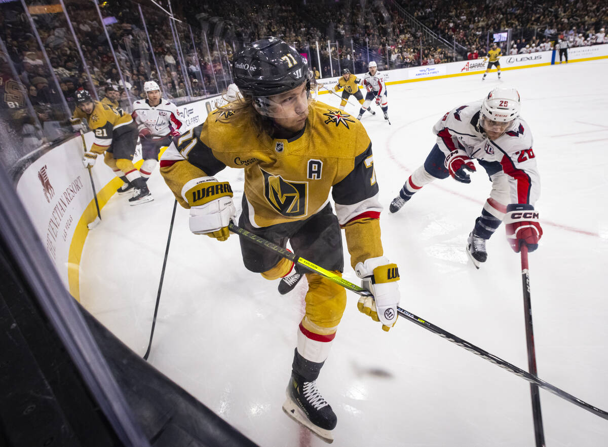 Golden Knights center William Karlsson (71) passes the puck under pressure from Washington Capi ...