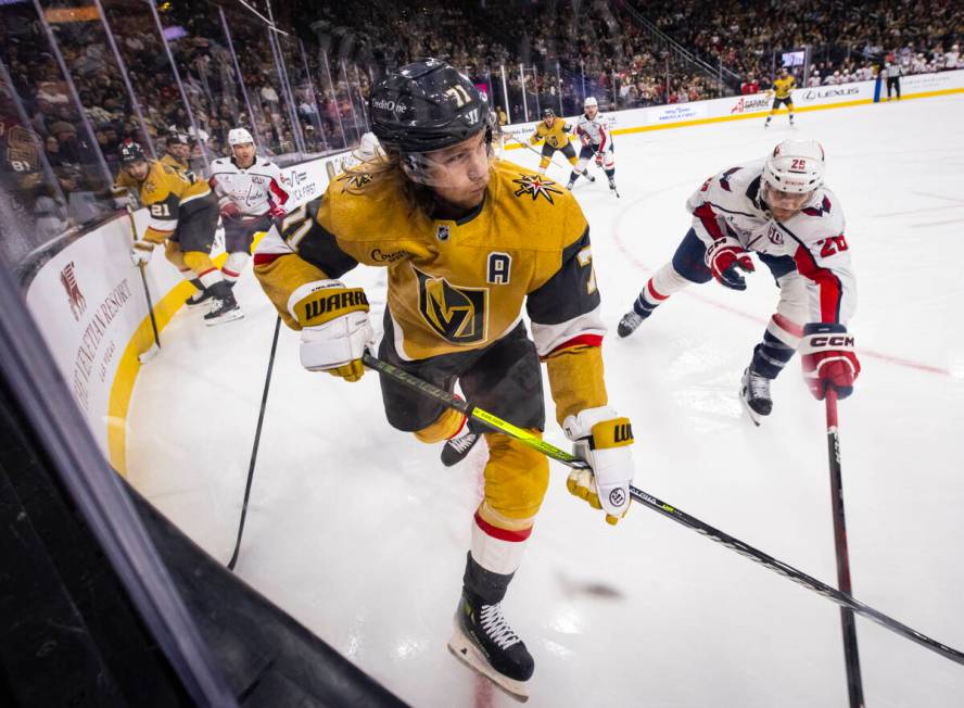 Golden Knights center William Karlsson (71) passes the puck under pressure from Washington Capi ...