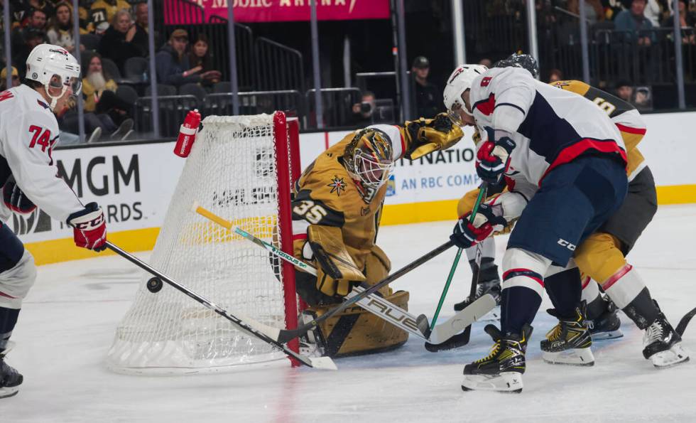 Golden Knights goaltender Ilya Samsonov (35) defends the net as Washington Capitals defenseman ...