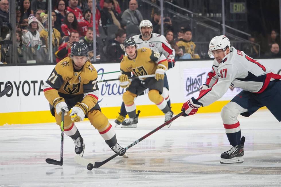 Washington Capitals center Dylan Strome (17) steals the puck from Golden Knights center William ...