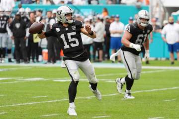 Las Vegas Raiders quarterback Gardner Minshew (15) aims a pass during the second half of an NFL ...