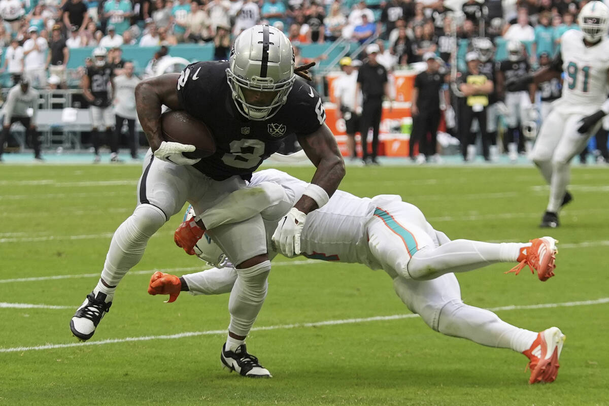 Las Vegas Raiders running back Ameer Abdullah (8) breaks up a tackle by Miami Dolphins cornerba ...