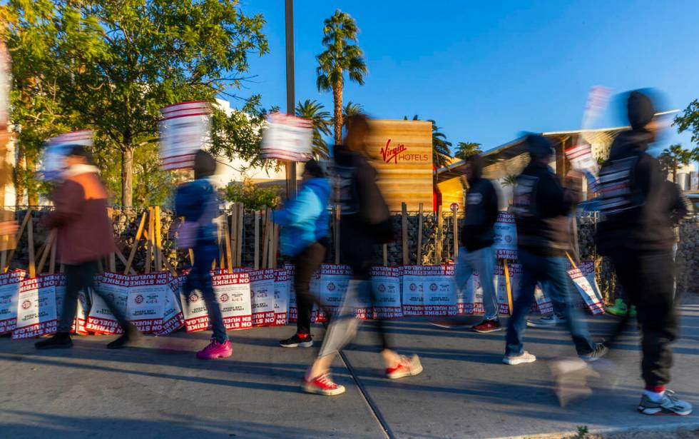 Culinary Local 226 workers on strike on the sidewalk near the main entrance outside the Virgin ...