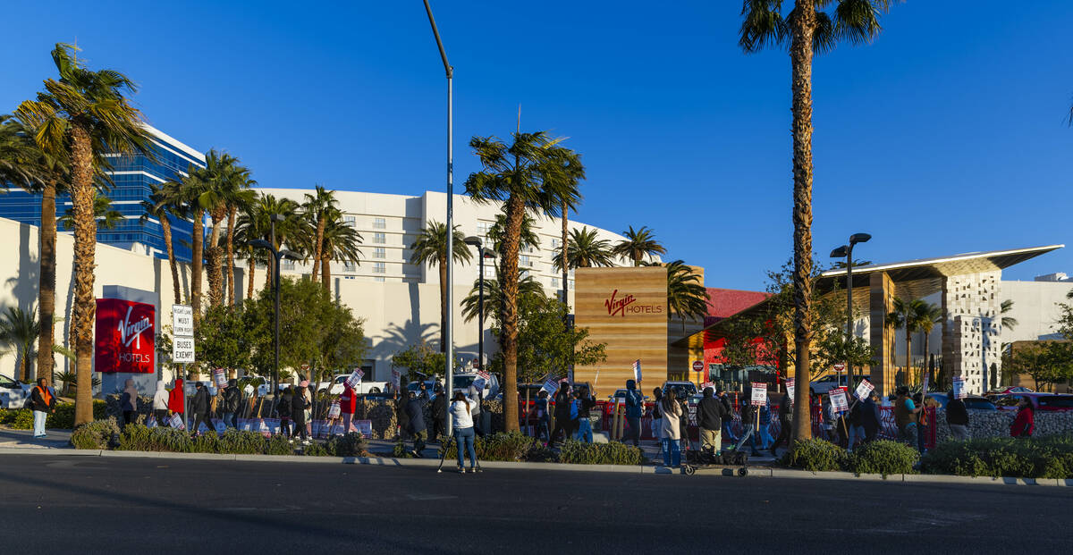 Culinary Local 226 workers on strike on the sidewalk near the main entrance outside the Virgin ...