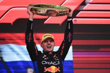 Red Bull driver Max Verstappen, of the Netherlands, celebrates on the podium his first place in ...