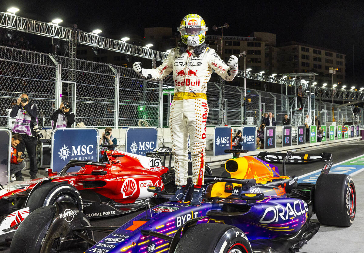 Red Bull Racing driver Max Verstappen celebrates his win atop his Red Bull Racing car following ...