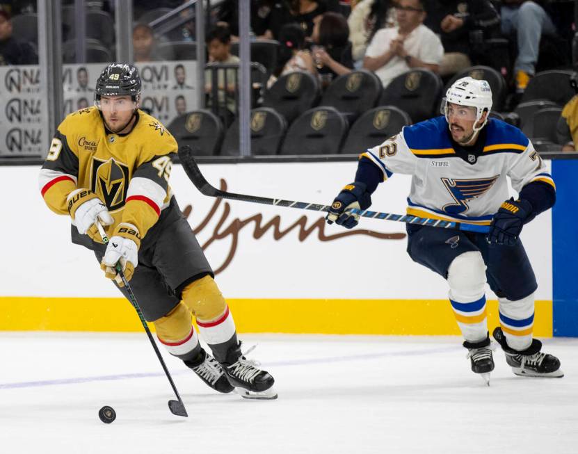 Golden Knights center Ivan Barbashev (49) keeps the puck from St. Louis Blues defenseman Justin ...