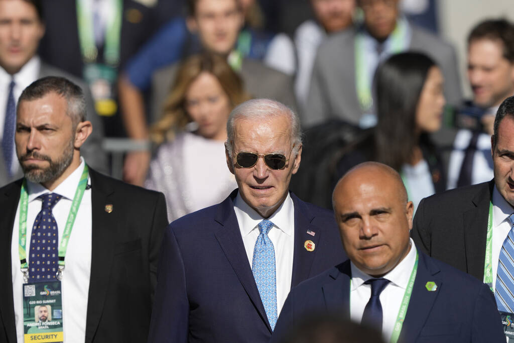 U.S. President Joe Biden arrives late for the group photo during the G20 Summit in Rio de Janei ...