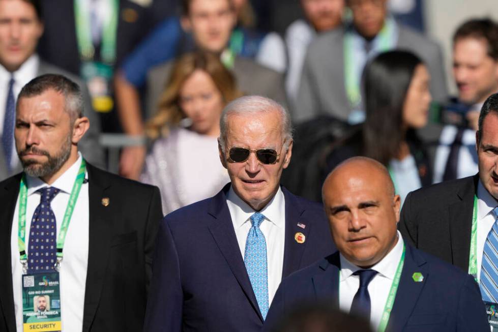 U.S. President Joe Biden arrives late for the group photo during the G20 Summit in Rio de Janei ...