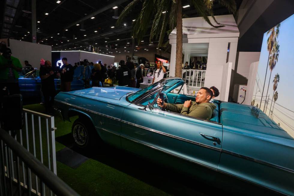 Cameron Butt records himself inside a car at a Gin & Juice pop up during ComplexCon at the Las ...