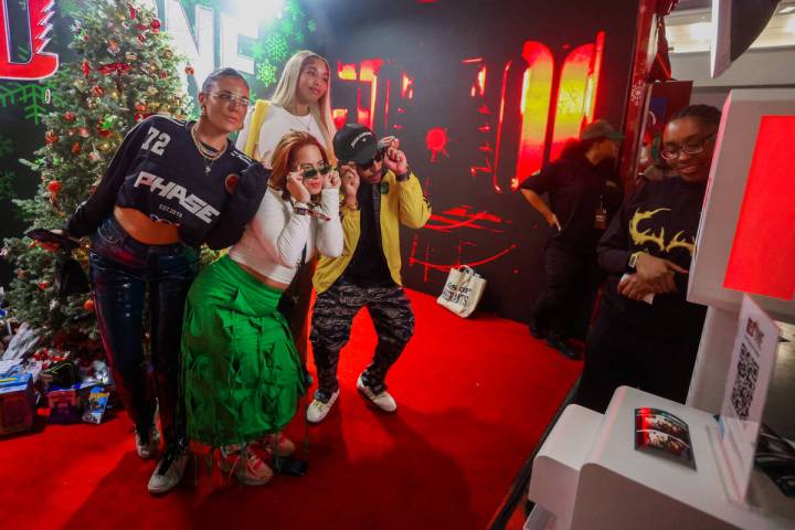 Attendees take photos at a photo booth during ComplexCon at the Las Vegas Convention Center on ...