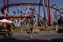 A young visitor runs past a ride to catch up with her family during the Knott's Taste of Boysen ...