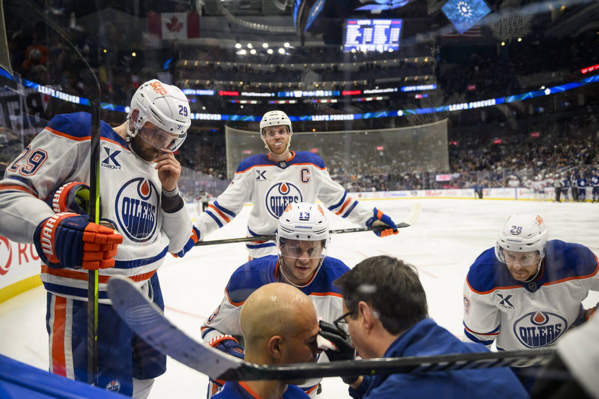 Edmonton Oilers defenseman Darnell Nurse (25) is attended to by medical personnel and teammates ...