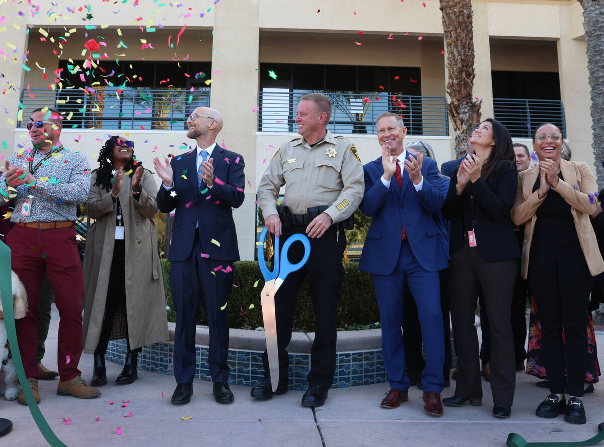 Sheriff Kevin McMahill, center, Dr. James Tenney, director of the Wellness Bureau, left, and Ja ...