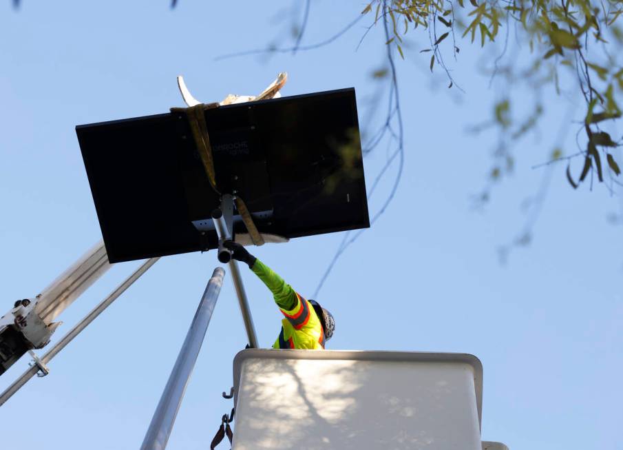 A worker from Clark County’s Public Works Department installs one of the 12 new solar streetl ...