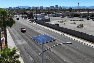 One of 12 new solar streetlights is seen at the corner of East St. Louis Avenue and Palm Street ...