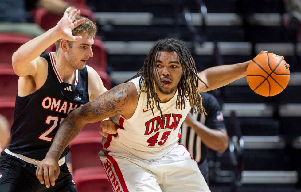 Omaha Mavericks forward Joshua Streit, left, and UNLV forward Jeremiah Cherry (45) compete duri ...