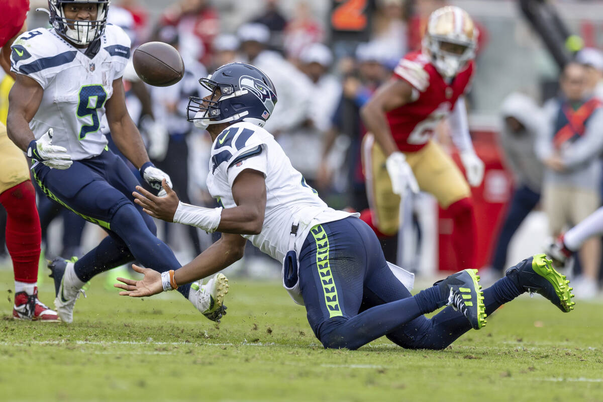 Seattle Seahawks quarterback Geno Smith (7) catches a fumbled ball against the San Francisco 49 ...