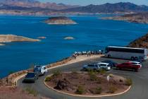 A tour bus drops off passengers to view Lake Mead from the Lakeview Overlook on Aug. 15, 2024, ...