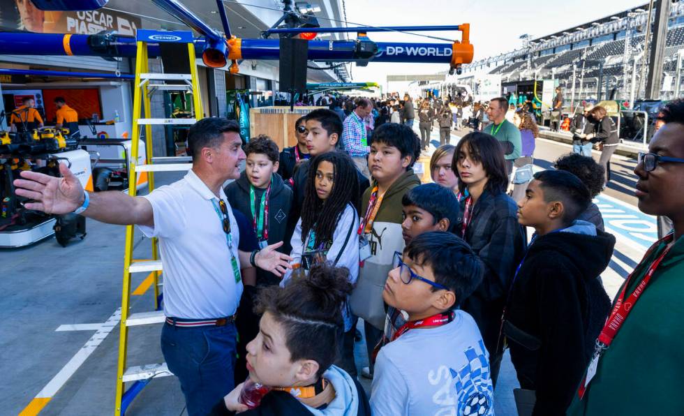 McLaren test driver Andre D'Cruze interacts with Kenny C. Guinn Middle School students as a mem ...