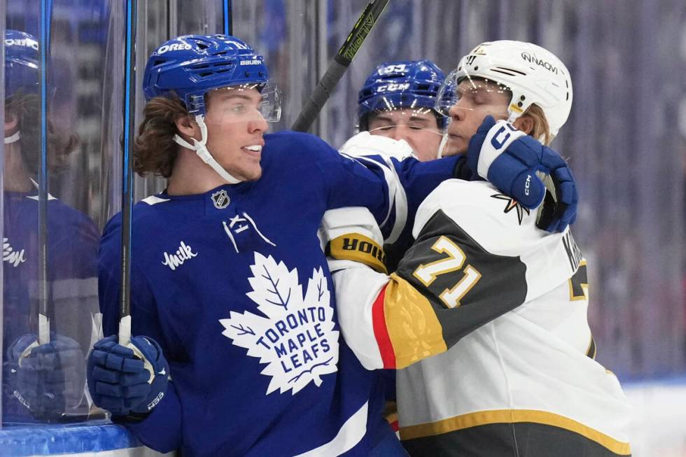 Toronto Maple Leafs Nikita Grebenkin (71) tangles on the boards with Vegas Golden Knights Willi ...