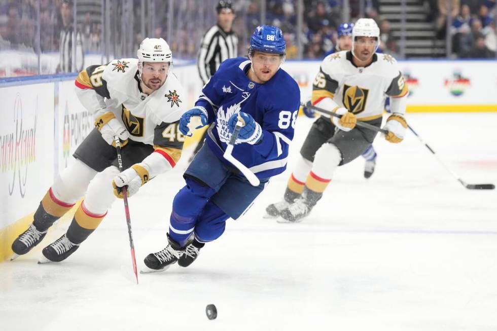 Toronto Maple Leafs' William Nylander (88) and Vegas Golden Knights' Tomas Hertl (48) chase dow ...