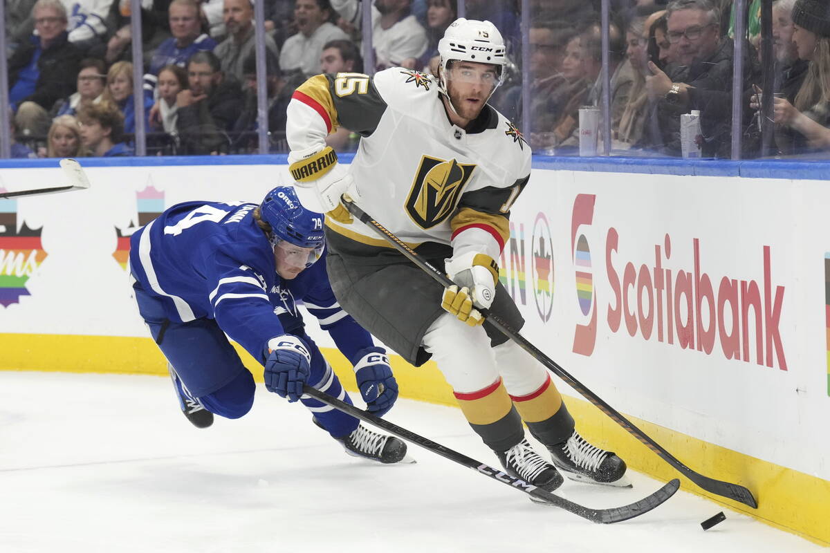 Vegas Golden Knights Noah Hanifin (15) and Toronto Maple Leafs Bobby McMann (74) battle for the ...