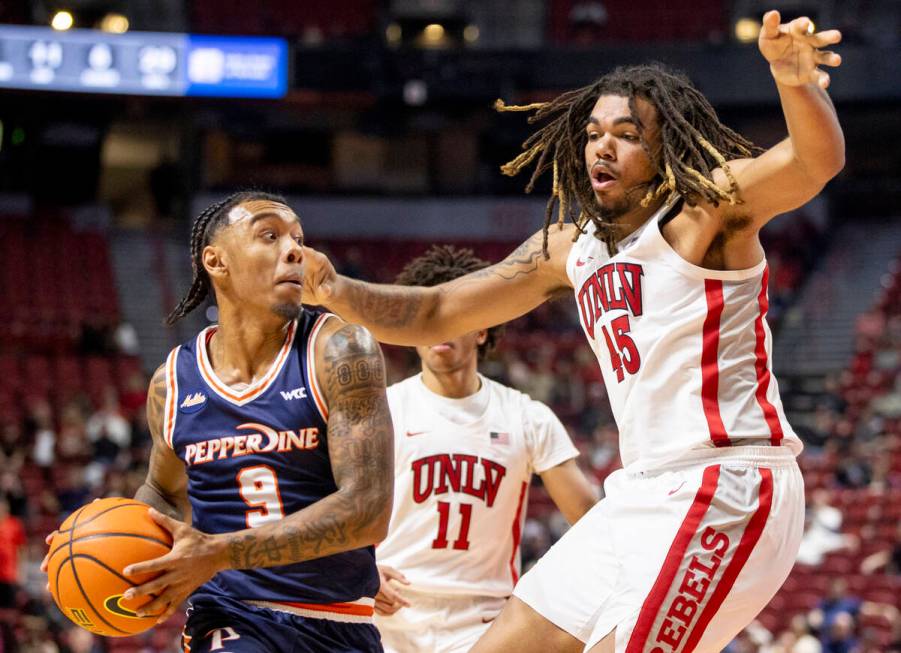 UNLV forward Jeremiah Cherry (45) defends Pepperdine Waves guard Taj Au-Duke (9) during the col ...