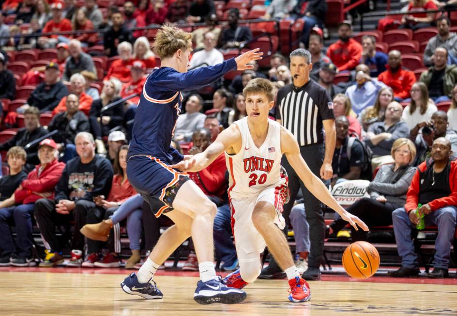 UNLV guard Julian Rishwain (20) attempts to juke out Pepperdine Waves guard Jaxon Olvera, left, ...