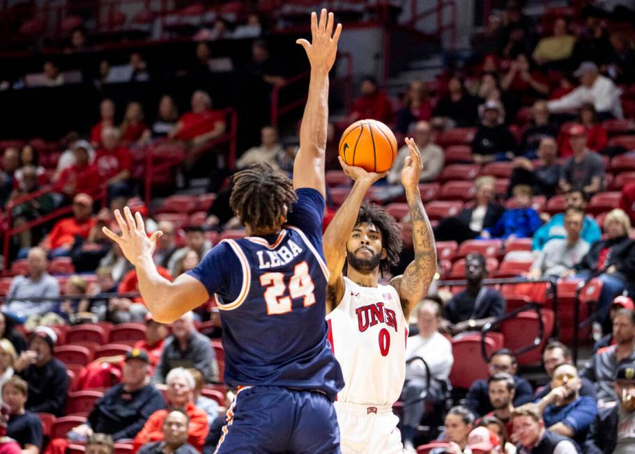 UNLV forward Isaiah Cottrell (0) attempts a three-point shot over Pepperdine Waves center Alex ...