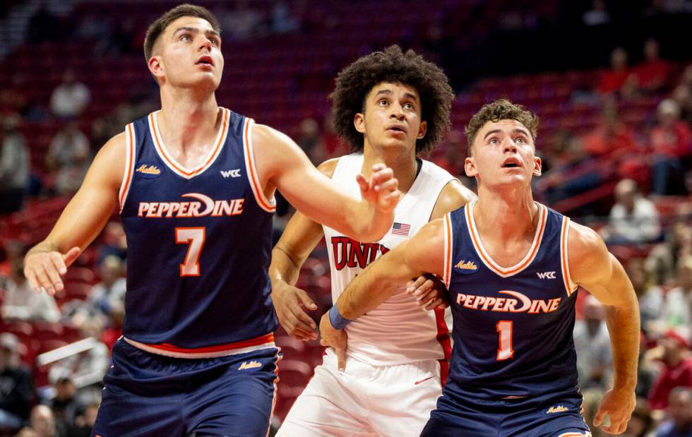 Pepperdine Waves forward Stefan Todorovic (7), UNLV forward Jalen Hill, center, and Pepperdine ...