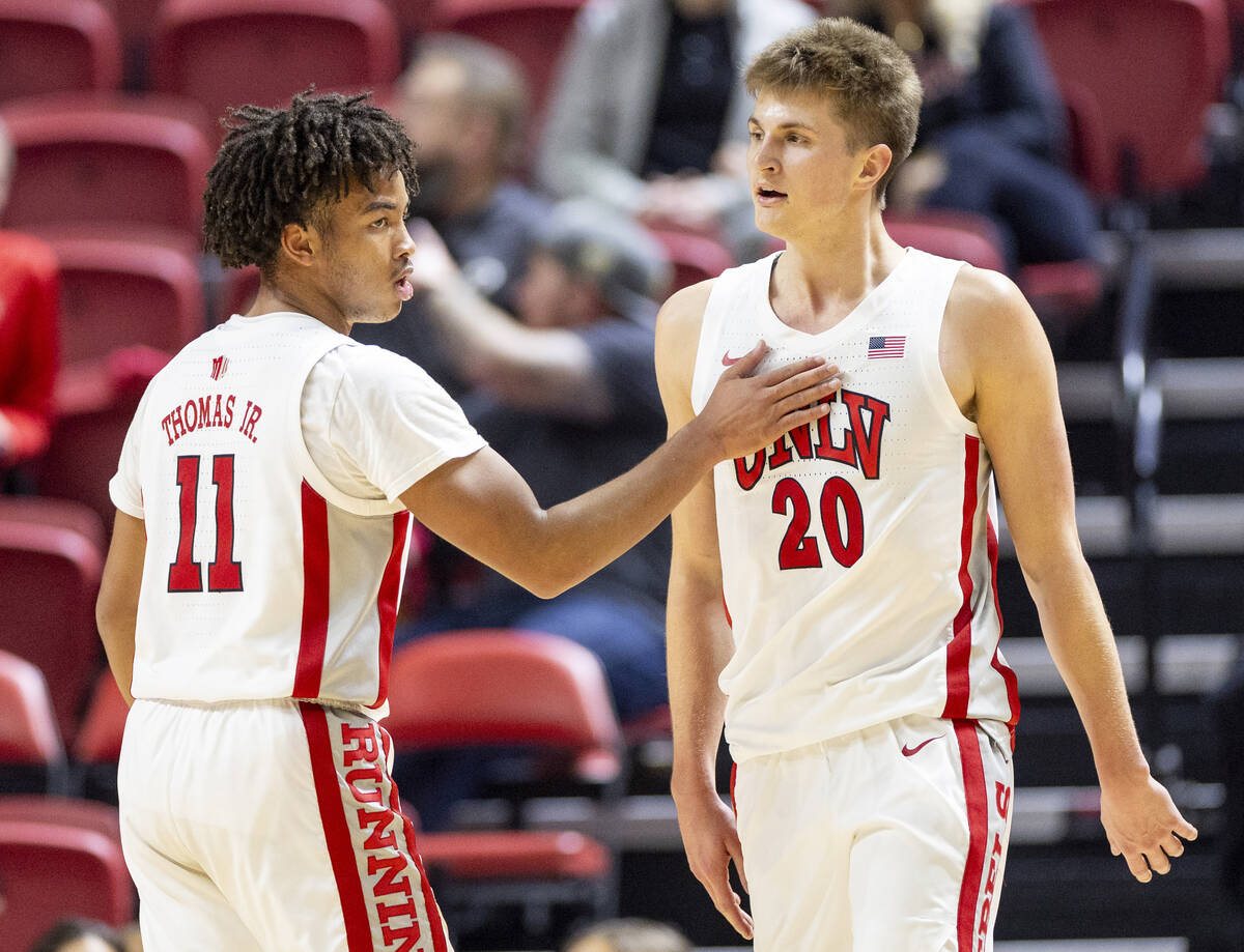 UNLV guard Dedan Thomas Jr. (11) and guard Julian Rishwain (20) celebrate a play during the col ...