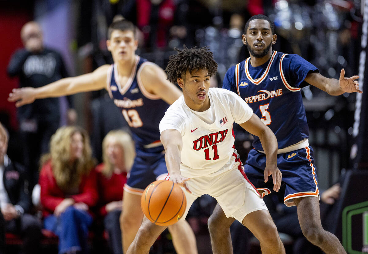 UNLV guard Dedan Thomas Jr. (11) passes the ball during the college basketball game against the ...