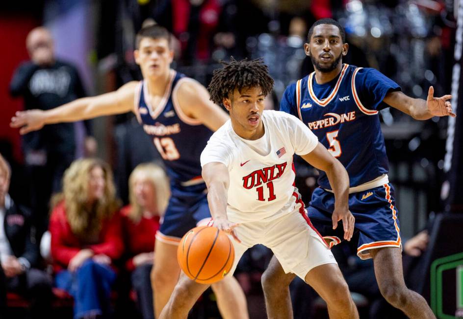 UNLV guard Dedan Thomas Jr. (11) passes the ball during the college basketball game against the ...