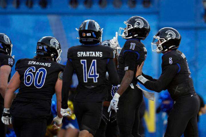 San Jose State wide receiver Justin Lockhart (11) celebrates with teammates after scoring again ...