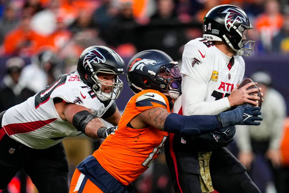 Denver Broncos linebacker Nik Bonitto (15) sacks Atlanta Falcons quarterback Kirk Cousins (18) ...