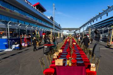 Servers and other contractors continue to set of tables for a pre-race dining experience on the ...